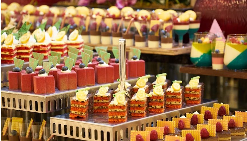 An elegant corporate catering display of colourful dessert verrines and canapés